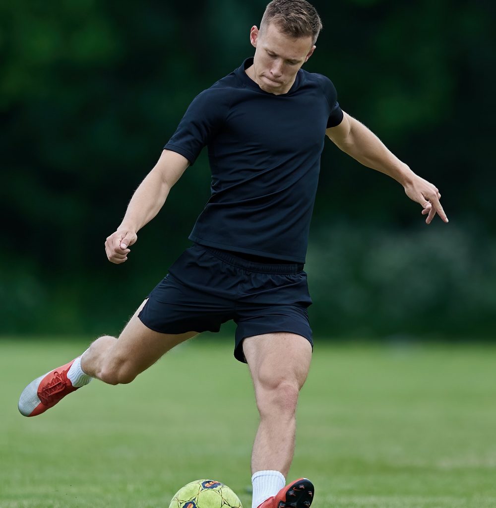 Football player kicking a ball